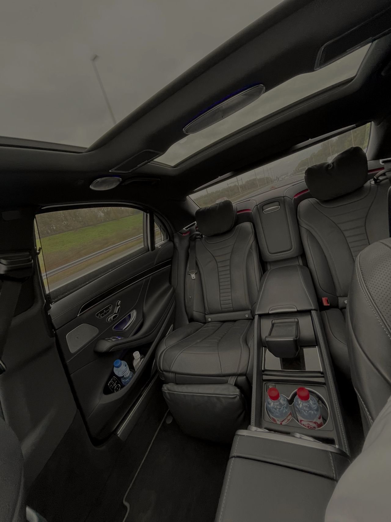 Two rear seats with a centre console inside a saloon car