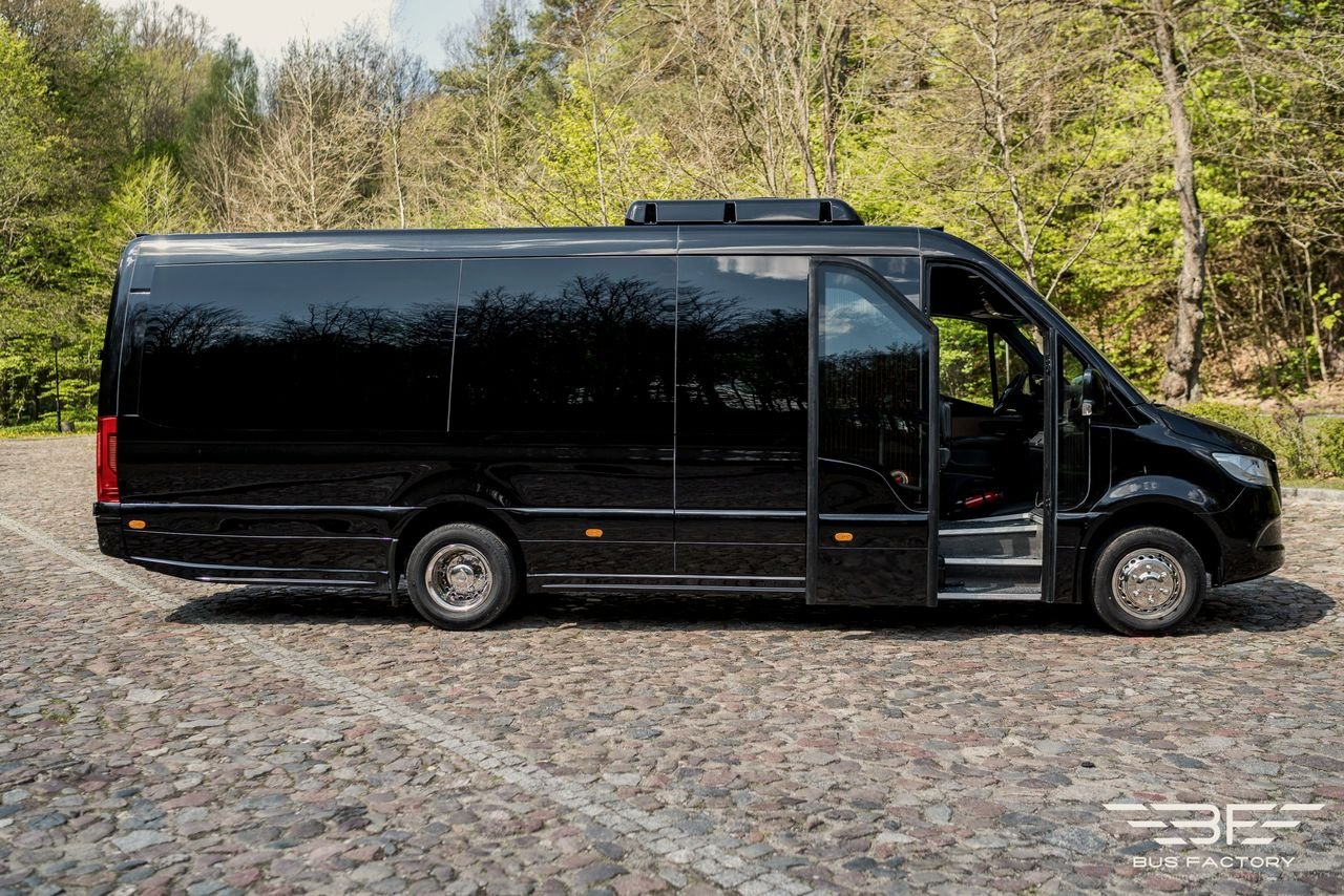 Side view of a black Sprinter minibus with its passenger door open